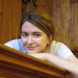 Audrey Borowski in a white shirt, leaning over a banister 