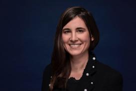 Stefanie Rudolf (long hair, facing to the camera) in front of a dark blue background