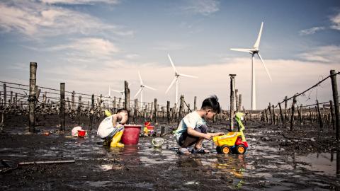 Children playing in a dried up seabed