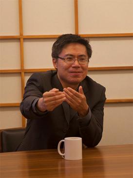 profile picture of Fa-ti Fan, sitting at a desk with a coffee mug